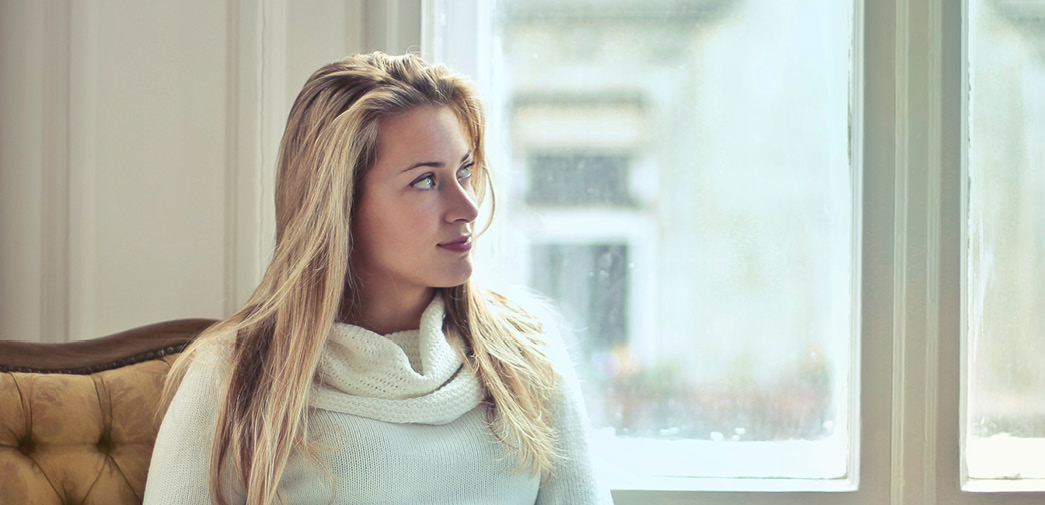 A female customer looks off, thoughtfully, into the distance.