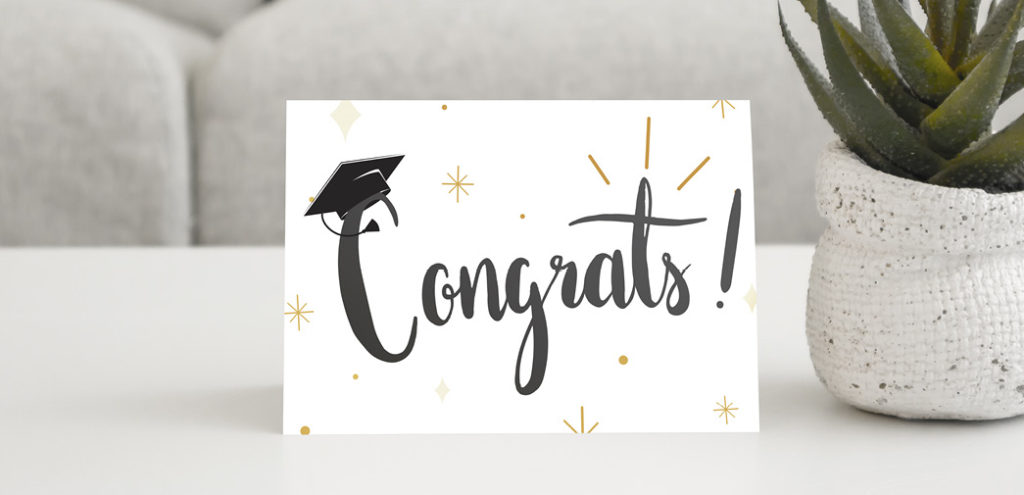 A greeting card featuring the word "Congrats" with a graduation hat resting on the top of the letter C