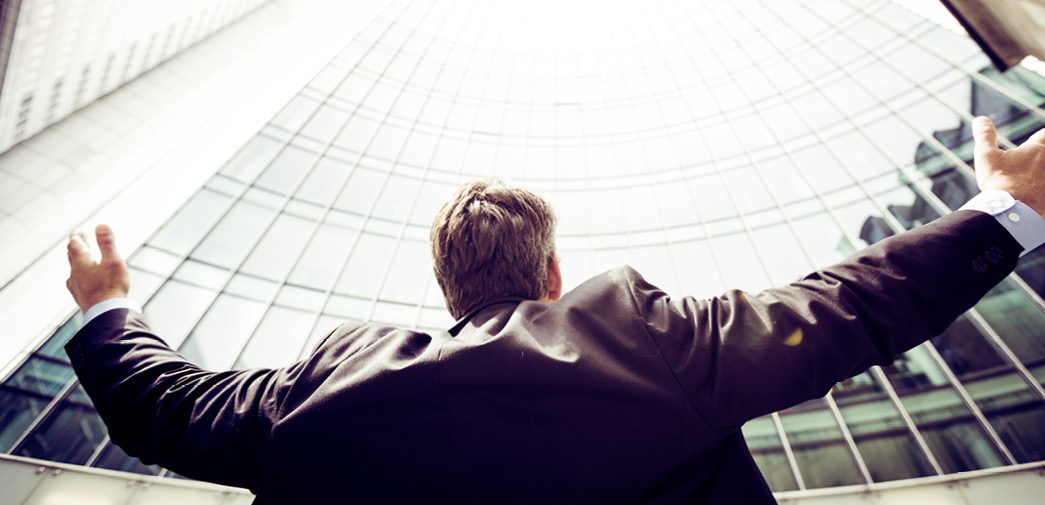 A financial advisor raises their hands in the air