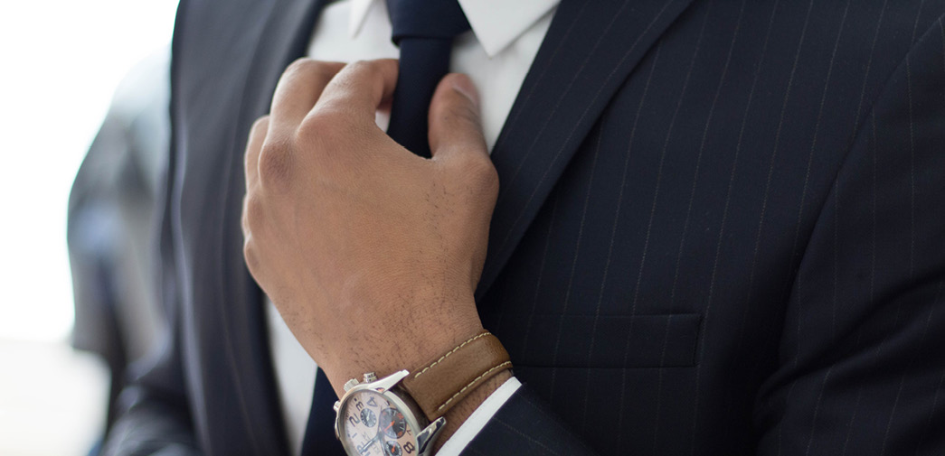 An advisor adjusts his tie