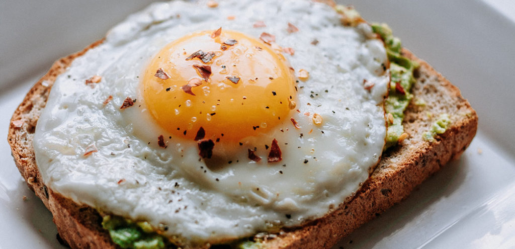 A cooked egg on a slice of bread