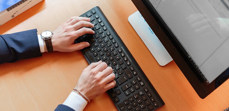 man typing on computer
