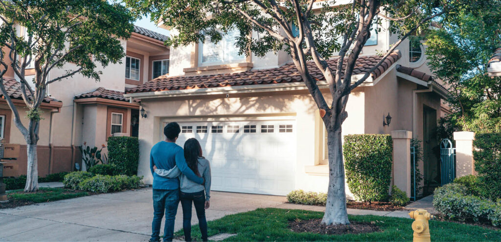 Man and woman standing in front of a house